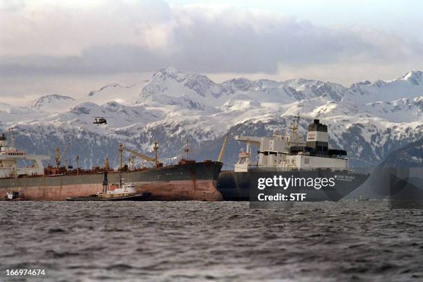 Helicopter prepares to land on the deck of the oil tanker Exxon Baton Rouge on March 26, 1989 during the offloading of crude oil from the crippled...