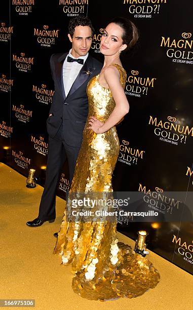 Designer Zac Posen and actress Caroline Correa wearing a Zac Posen one-of-a-kind 24k gold dress valued at $1.5 million attend the premiere of "As...