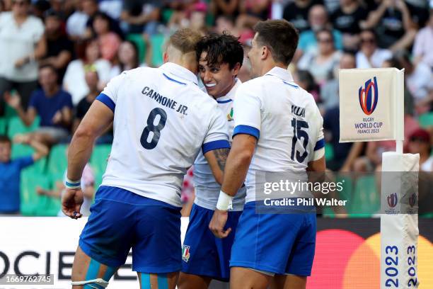 Ange Capuozzo of Italy celebrates with Lorenzo Cannone and Tommaso Allan of Italy after scoring his team's fourth try during the Rugby World Cup...