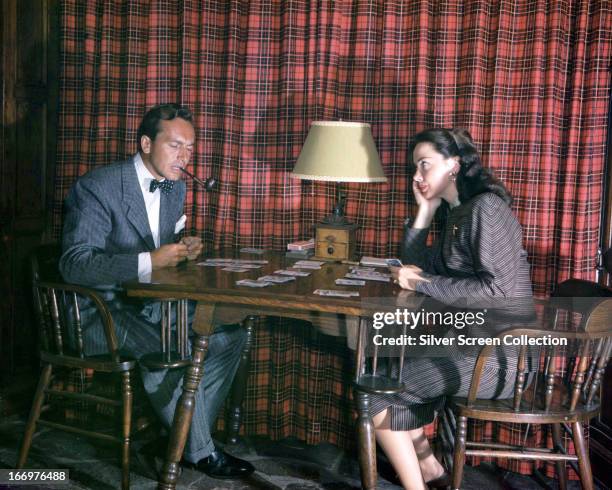 American actress Kathryn Grayson and her husband, actor and singer Johnnie Johnston , playing cards together, circa 1950.