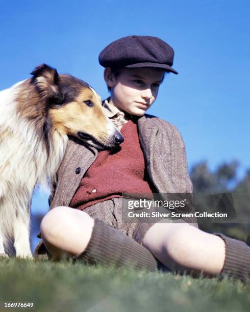 English actor Roddy McDowall with the rough collie Pal in a promotional portrait for 'Lassie Come Home', directed by Fred M. Wilcox, 1943.