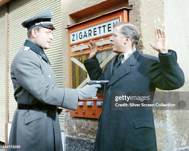 Squadron Leader Roger Bartlett is captured by SS-Obersturmführer Steinach in 'The Great Escape', directed by John Sturges, 1963.