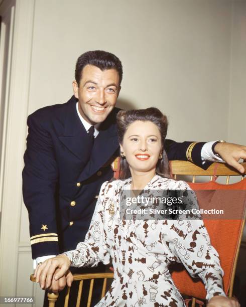American actors Robert Taylor and his wife Barbara Stanwyck , circa 1945. Taylor is wearing the uniform of the United States Naval Air Corps.