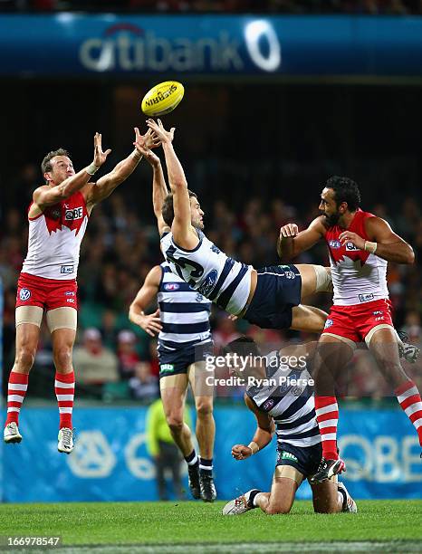 Jared Rivers of the Cats flies for a mark against Jude Bolton of the Swans during the round four AFL match between the Sydney Swans and the Geelong...