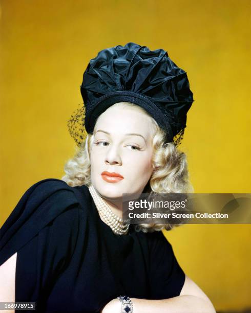 American actress Betty Hutton wearing a hat in black, ruched satin, circa 1950.