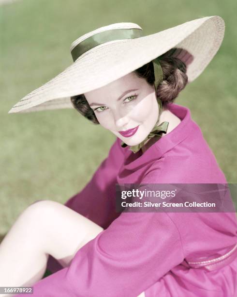 American actress Gene Tierney wearing a wide-brimmed sunhat, circa 1945.