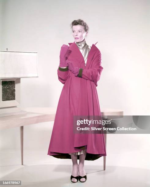 American actress Katharine Hepburn wearing a pink coat and matching gloves, circa 1955.