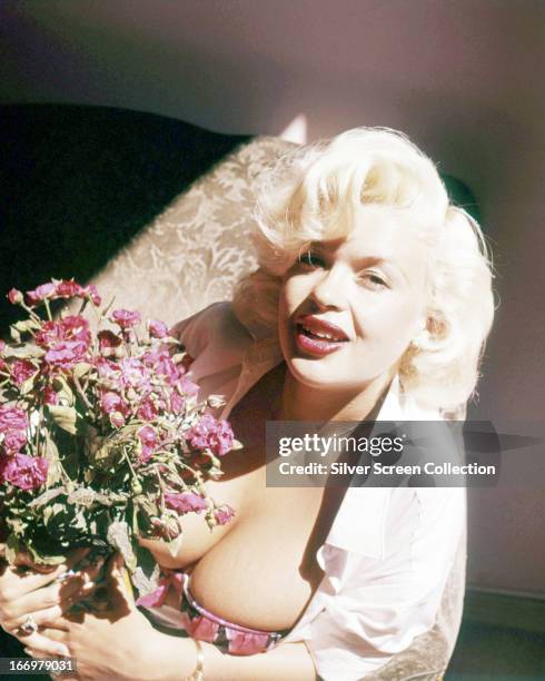 American actress Jayne Mansfield holding a bouquet, circa 1955.