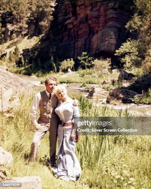 English actor Kenneth More as Jonathan Tibbs, and American actress Jayne Mansfield as Kate, in 'The Sheriff of Fractured Jaw', directed by Raoul...