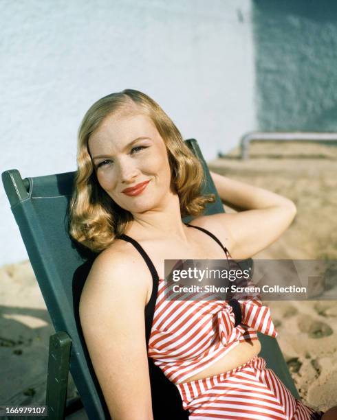 American actress and model Veronica Lake in a red and white striped beach outfit, circa 1945.