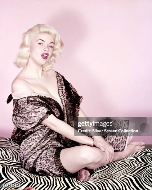 American actress Jayne Mansfield sitting cross-legged, circa 1955.