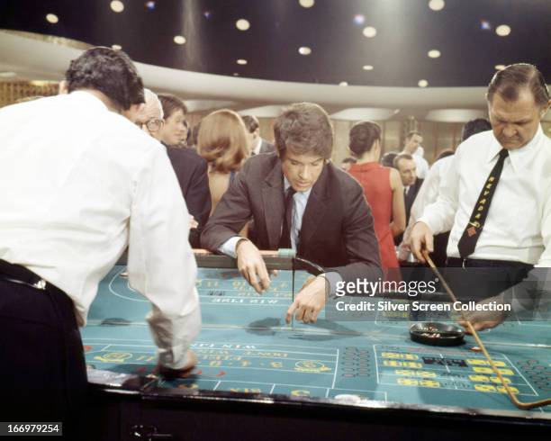 Joe Grady, played by American actor Warren Beatty, visits a casino in 'The Only Game in Town', directed by George Stevens, 1970.
