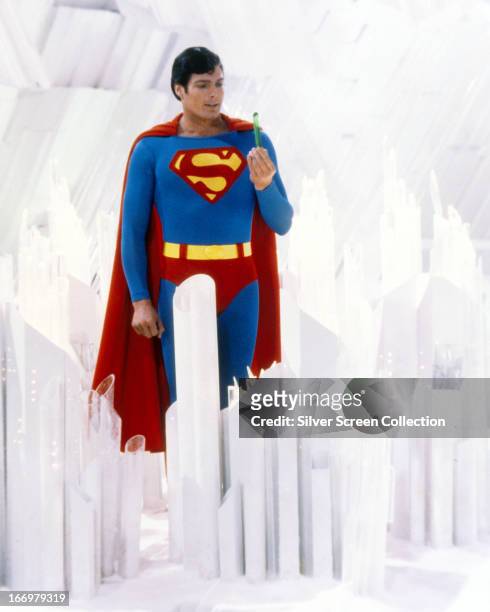 Superman, played by American actor Christopher Reeve , holds a green crystal at the Fortress of Solitude, in a promotional still from 'Superman',...