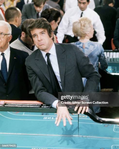 Joe Grady, played by American actor Warren Beatty, visits a casino in 'The Only Game in Town', directed by George Stevens, 1970.