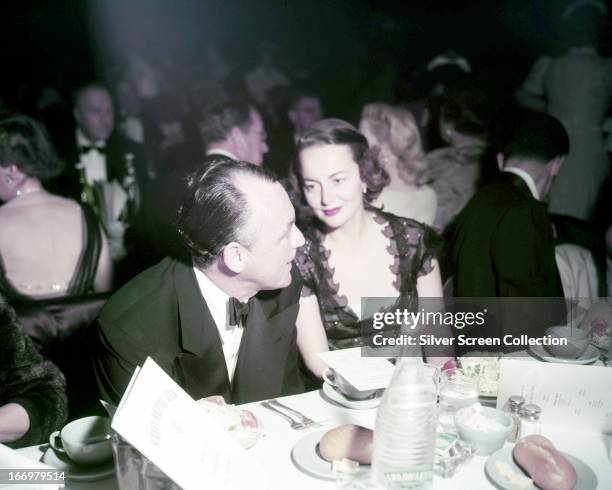 British-American actress Olivia de Havilland at a formal dinner, circa 1945.