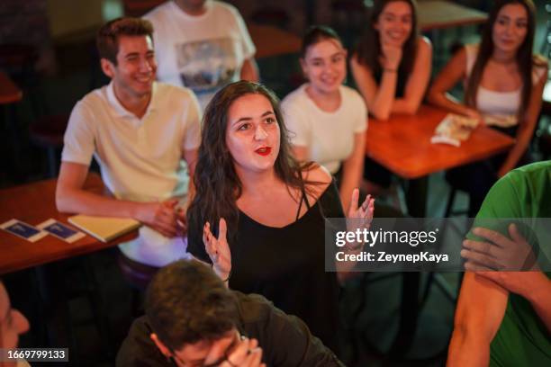 audience asking questions to the speakers on the stage at the conference - television host stock pictures, royalty-free photos & images