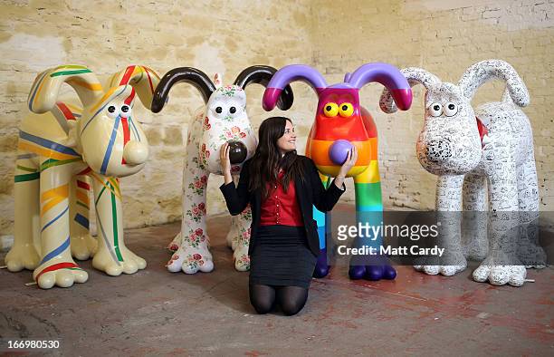 Fundraising manager Lauren Vincent poses with four Gromit sculptures, out of around 70 which have been painted by celebrity artists, Sir Paul Smith,...