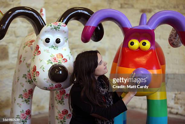 Fundraising manager Lauren Vincent poses with two Gromit sculptures, out of around 70 which have been painted by celebrity artists, Cath Kidston and...