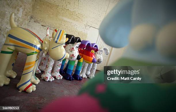 Four Gromit sculptures, of around 70, that have been painted by celebrity artists, left to right, Sir Paul Smith, Cath Kidston, Richard Williams and...