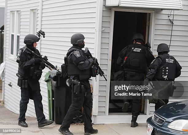 Team members search for one remaining suspect at a residential building on April 19, 2013 in Watertown, Massachusetts. Earlier, a Massachusetts...