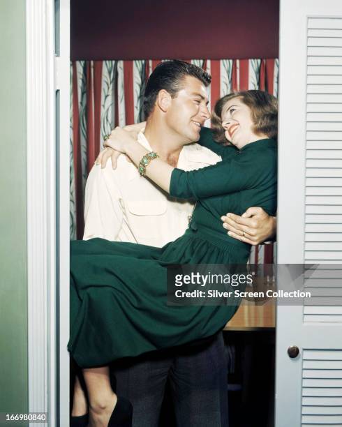 French actress Corinne Calvet in the arms of her first husband, American actor John Bromfield , circa 1950.