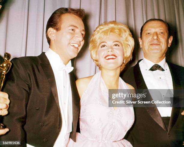 American singer Bobby Darin and his wife, actress Sandra Dee with composer Harry Sukman , at the 33rd Academy Awards, Santa Monica, California, 17th...