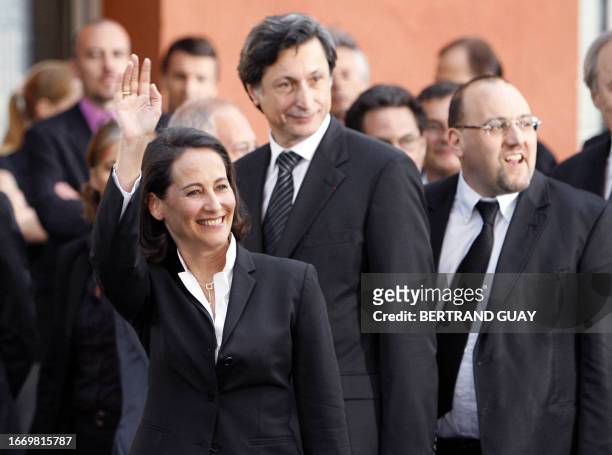 French Socialist Party presidential candidate Segolene Royal waves to the crowd, next to her party spokesman Julien Dray and Patrick de Carolis,...
