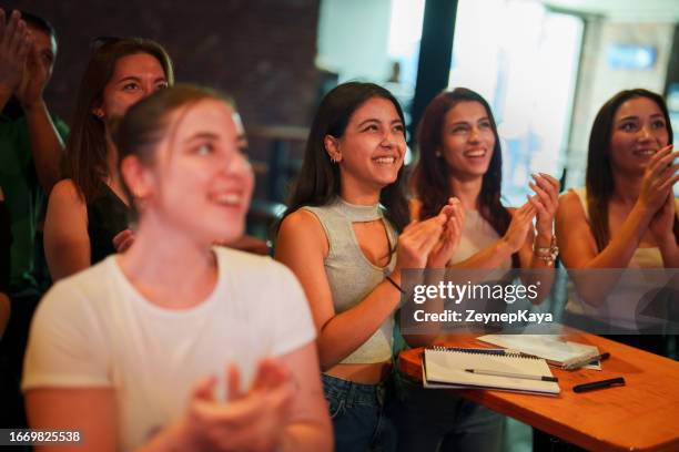 audience clapping hands to the speakers on the stage at the conference - clapping hands stock pictures, royalty-free photos & images