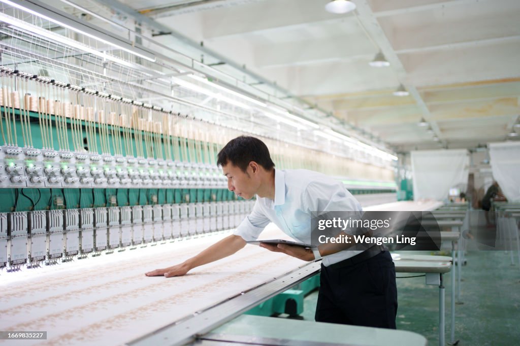 Skilled worker inspecting loom