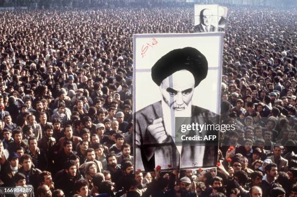 Demonstrators hold a poster of Ayatollah Ruhollah Khomeini, in January 1979, in Teheran, during a demonstration against the shah.