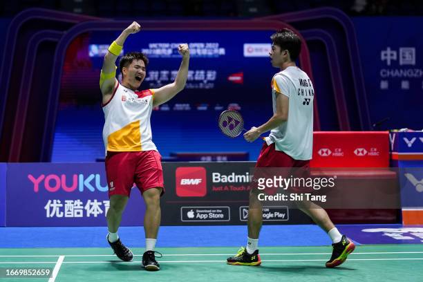 Liang Weikeng and Wang Chang of China celebrate the victory in the Men's Doubles Semi Finals match against Takuro Hoki and Yugo Kobayashi of Japan on...