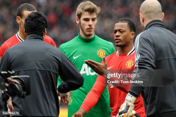 Luis Suarez of Liverpool refuses to shake the hand of Patrice Evra of Manchester United ahead of the Barclays Premier League match between Manchester...