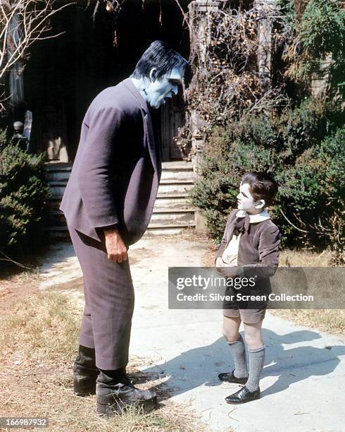 American actors Fred Gwynne as Herman Munster and Butch Patrick as Eddie Munster in the TV comedy horror series 'The Munsters', circa 1965.