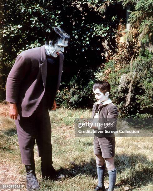 American actors Fred Gwynne as Herman Munster and Butch Patrick as Eddie Munster in the TV comedy horror series 'The Munsters', circa 1965.
