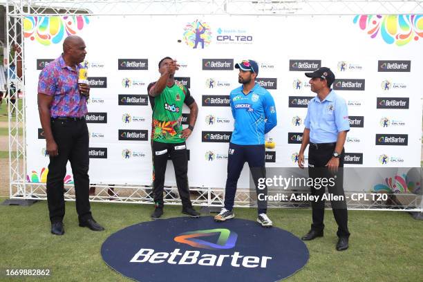 Evin Lewis, captain of St Kitts & Nevis Patriots flicks the coin as Sikandar Raza, captain of St Lucia King looks on ahead of play during the...