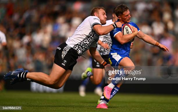 Tom Cairns of Exeter Chiefs breaks the tackle of Fred Davies of Bristol Bears to score their sides fourth try during the Premiership Rugby Cup match...