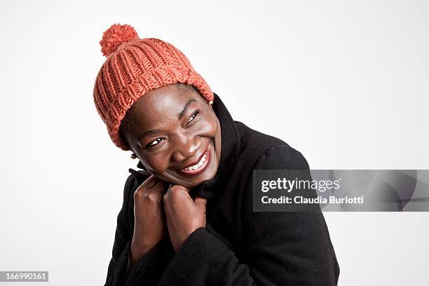 happy african lady felling cold - cappello di lana foto e immagini stock