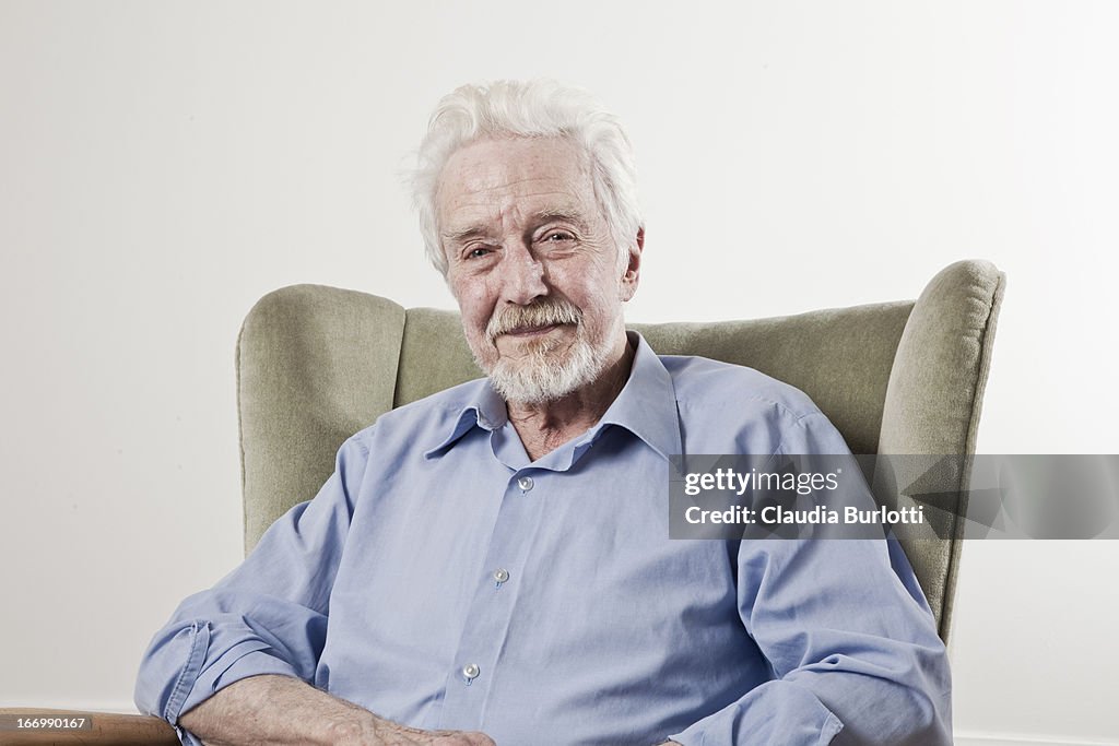 Happy Old Man Sitting on a Chair