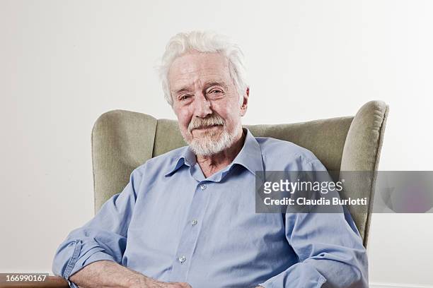 happy old man sitting on a chair - grey beard stock pictures, royalty-free photos & images
