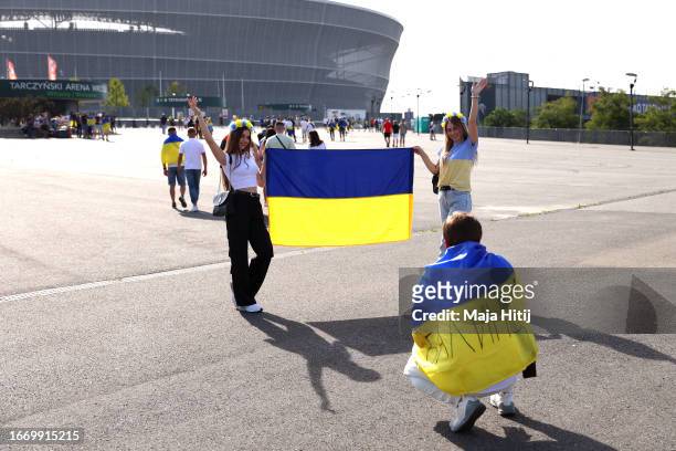 Fans of Ukraine pose for a photo with the flag of Ukraine outside the stadium prior to the UEFA EURO 2024 European qualifier match between Ukraine...