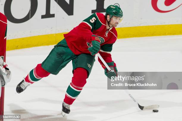 Brett Clark of the Minnesota Wild passes the puck against the Columbus Blue Jackets during the game on April 13, 2013 at the Xcel Energy Center in...