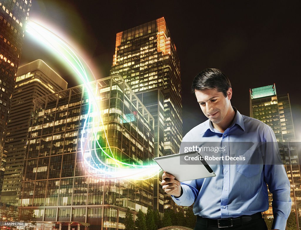 Business man using tablet with city scape behind