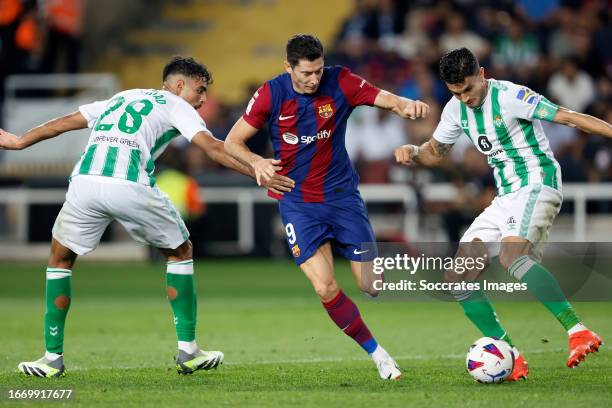 Chadi Riad of Real Betis, Robert Lewandowski of FC Barcelona, Marc Bartra of Real Betis during the LaLiga EA Sports match between FC Barcelona v Real...