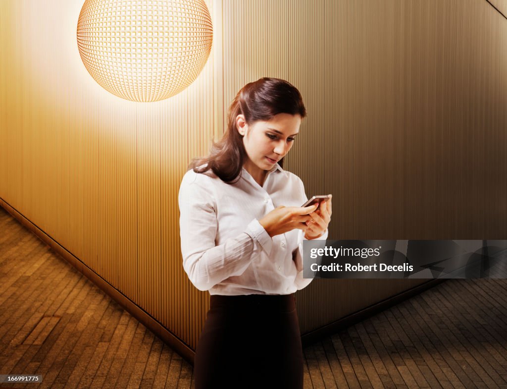 Woman using mobile with wifi hot spot behind