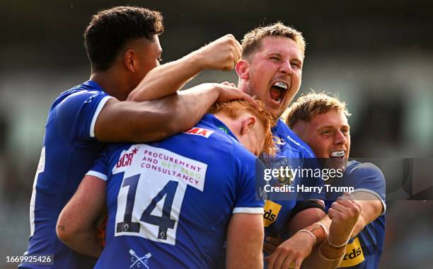 Ben Hammersley of Exeter Chiefs celebrates their sides seventh try with team mate Lewis Pearson during the Premiership Rugby Cup match between Exeter...