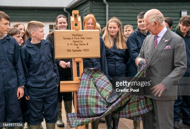 King Charles III, standing with farming and rural skills students, officially opens the MacRobert Farming and Rural Skills Centre at Dumfries House...