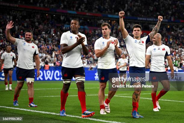 Cameron Woki, Damian Penaud and Matthieu Jalibert of France celebrate after winning the Rugby World Cup France 2023 match between France and New...
