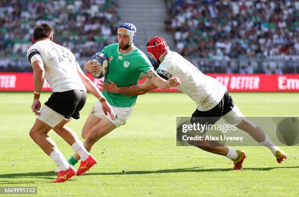 Robbie Henshaw of Ireland is challenged by Adrian Motoc of Romania during the Rugby World Cup France 2023 match between Ireland and Romania at...