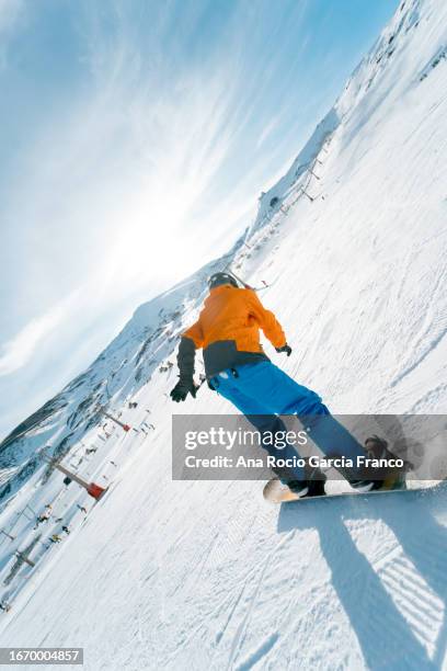 a young man snowboarding on the top of the mountain - andalucian sierra nevada stock pictures, royalty-free photos & images