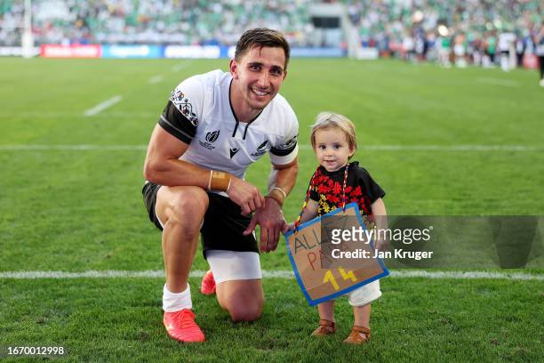 Nicholas Onutu of Romania poses for a photograph with his child after defeat to Ireland during the Rugby World Cup France 2023 match between Ireland...